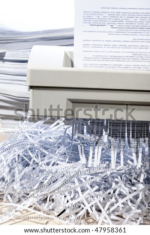 A confidential document being put through a shredder