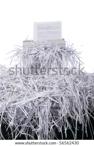 A confidential document being put through a shredder
