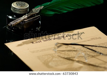 Old-fashioned paper with antique quill and text of Last will