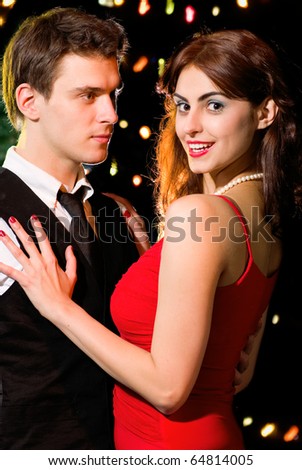 stock photo : Young happy loving couple dancing at Christmas (or Valentine's day) celebration