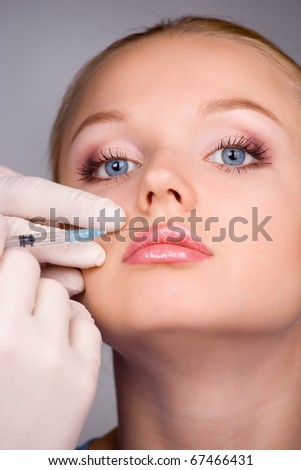 cosmetic injection to the pretty female face - close-up portrait