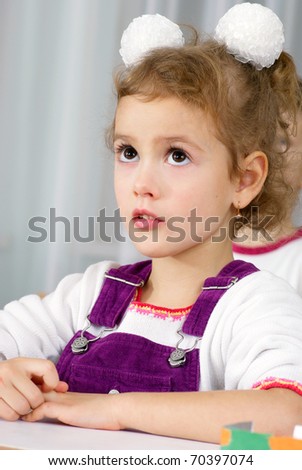 preschooler girl 4 years old listening a lesson in classroom