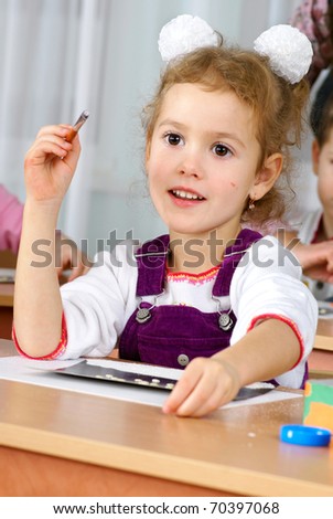 preschooler girl 4 years old drawing in classroom