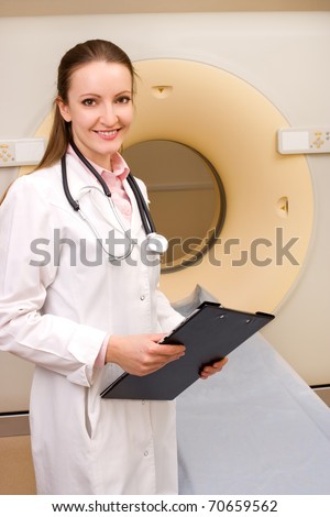 Woman Technologist with CT Scan Machine in hospital