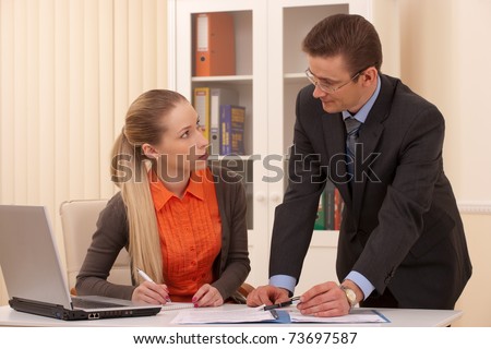 manager man and his secretary working together in the office