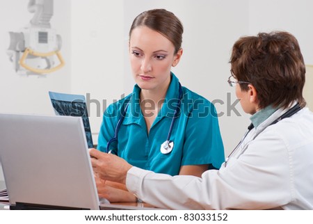 Senior woman professor explain to a young female medical student