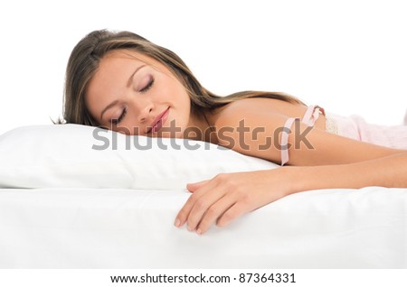 Beautiful young woman sleeping on bed in her bedroom