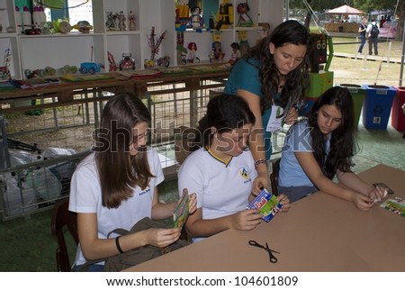 RIO DE JANEIRO - JUNE 04: unidentified group of girls and staff member accomplishing a task with recyclable material of a milk packing . Event Green Nation Fest,June 04, 2012 in Rio de Janeiro,Brazil