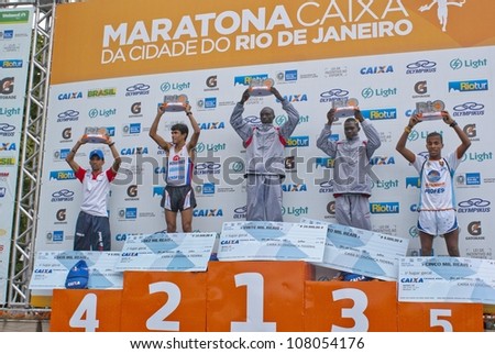 RIO DE JANEIRO-JULY8:at podium from left ot right Vianca N. Zeballos, Marcos A. Pereira, Willy C. Kmutai, David K. Metto, Alan B. de Jesus. Event Maratona do Rio,July 8,2012 at Rio de Janeiro,Brazil