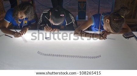 RIO DE JANEIRO - JULY 13: unidentified  group prepare elements of drawings in a film strip in the called workshop Pelicula. Event Anima Mundi, July 13, 2012 in Rio de Janeiro, Brazil.