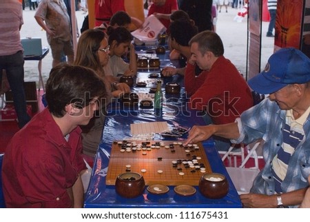 RIO DE JANEIRO - AUG 18: Japanese game Go. Japanese and Brazilian plays Go at the japanese party in Rio de Janeiro. August 18, 2012 in Rio de Janeiro, Brazil