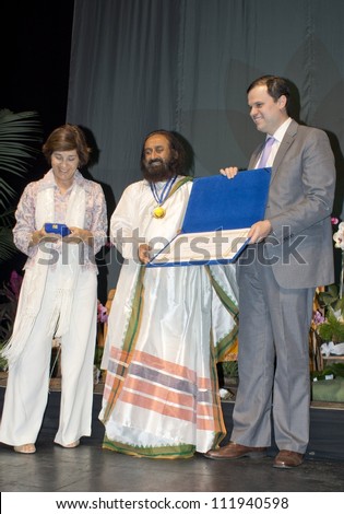 RIO DE JANEIRO - SET 03:Sri Sri Ravi Shankar from India receives the medal Tiradentes from deputy Andre Lazarone  during the event  Inspiracao e Lideranca, September 03, 2012 in Rio de Janeiro, Brazil
