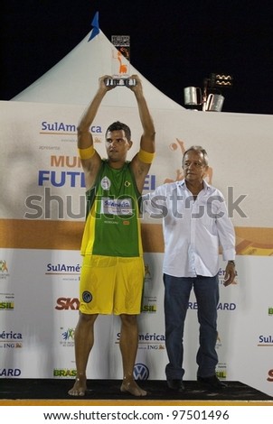 RIO DE JANEIRO - MARCH 10:Fabio of the Brasil 2 team  lifting player\'s trophy of the best player of the Cup  at II World Cup of Futevalei Sulamerica 4x4 event March 10, 2012 in Rio de Janeiro,  Brazil