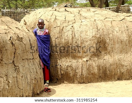 Masai woman near her house. The Masai are a Nilotic ethnic group of semi-nomadic people inhabiting southern Kenya and northern Tanzania, January 15th 2012, Kenya, Africa.