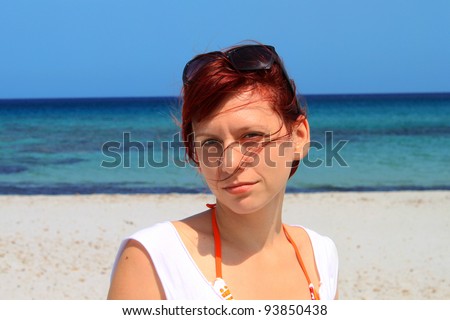 Happy young woman at the beach enjoying her summer holidays in Italy, Sardinia