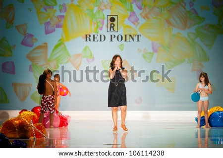 CANARY ISLANDS -JUNE 22: Designer Gemma Torrent Gisbert(m) with unidentified children onstage in the Red Point collection during Gran Canaria Moda Calida on June 22, 2012 in Canary Islands, Spain
