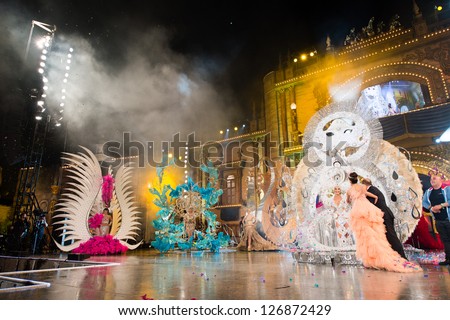 LAS PALMAS, SPAIN - FEBRUARY 1: Laura Medina(l) and Juan Jose Cardona(r) giving 1 prize to Giovanna Lee Alfonso (white costume) onstage during Queens Gala on February 1, 2013 in Las Palmas, Spain.