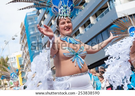 CANARY ISLAND, SPAIN - FEBRUARY 17, 2015: Unidentified women from Brisa de Volcan dancing samba in the streets during city of Las Palmas carnival in the sun.