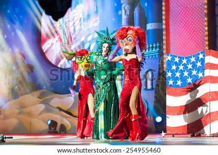 CANARY ISLAND, SPAIN - FEBRUARY 20, 2015: Drag Dafne del Giogio (m) as Statue of Liberty and unidentified assistants with comic costumes performing onstage during Las Palmas carnival Drag Queen Gala.