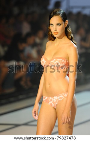 CANARY ISLANDS - 18 JUNE: Model Laura Medina wearing swimwear from Dos Mares Summer Collection at Moda Calida in Maspalomas June 18, 2011 in Canary Islands, Spain