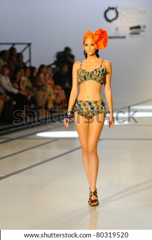CANARY ISLANDS -JUNE 18: A model walks the runway in the Adama Paris collection during Moda Calida in Maspalomas June 18, 2011 in Canary Islands, Spain
