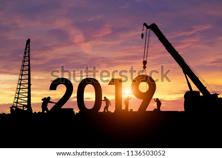 Silhouette workers work constructively to create. 2019 New Year