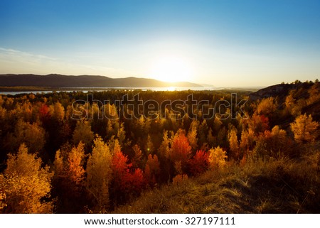 Amazing landscape of golden autumn with view of yellow forest from above at background.