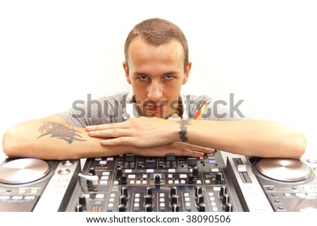 A happy DJ and his turntables, mixers, cd/mp3 players, funcky white headphones...