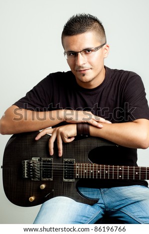 portrait of a young guitar player with his guitar
