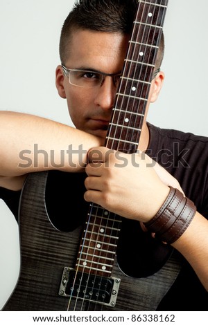 portrait of a young guitar player with his guitar