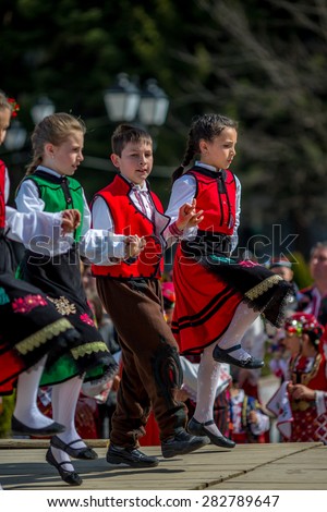 RAZLOG, BULGARIA - APRIL 13, 2015: Bulgarian children dancing on the stage during the traditional folklore festival 