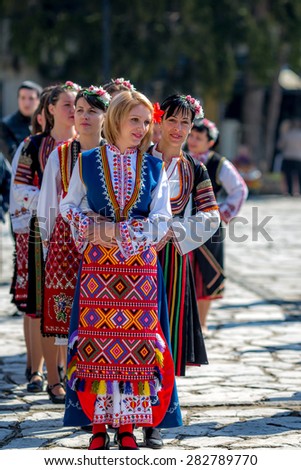 RAZLOG, BULGARIA - APRIL 13, 2015: Female Bulgarian folklore dancers in a line during the traditional folklore festival \