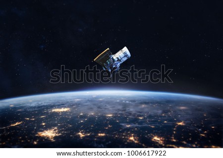 Night on the Earth and satellite in the space. City lights on planet. Civilization. Elements of this image furnished by NASA