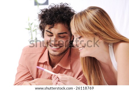 young couple smiling for pregnancy test, parental and couple love