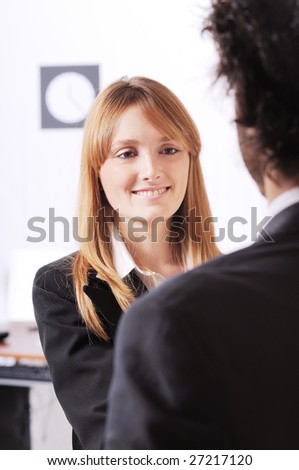 young businesswoman in the office speak with co-worker