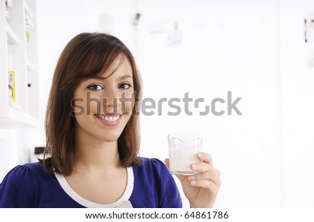 young woman drinking milk on the white background