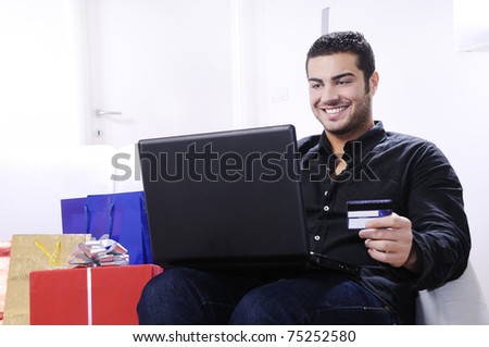 young man buying on internet with laptop in indoor