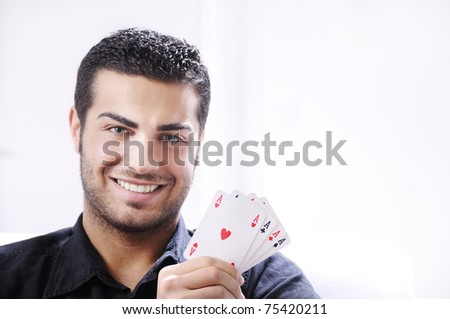 man with ace poker; four aces in hands; smiling and looking in camera.