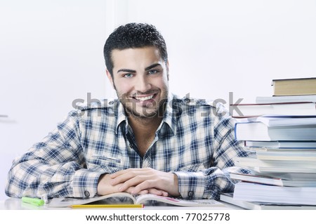 young student smiling with books on white background, concept of successful