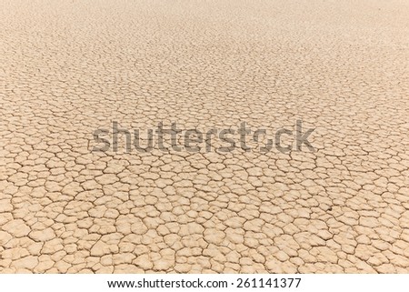 Dry lake bed with natural texture of cracked clay in perspective. Racetrack Playa floor. Death Valley