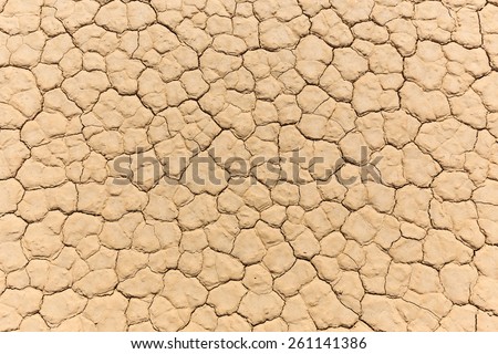 Natural mosaic texture of cracked mud on dry lake bed from above