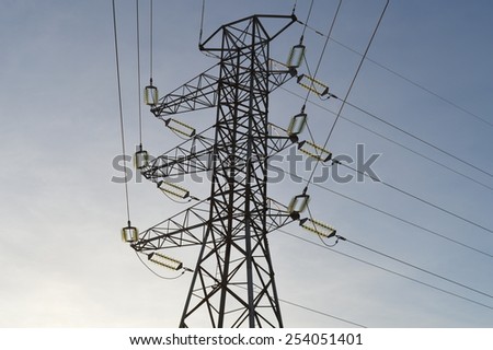 Closer view of a transmission tower with power lines. High voltage electricity pylon in Finland, Europe. Smart electric grid infrastructure.