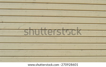 Old wooden wall with worn out pale white paint