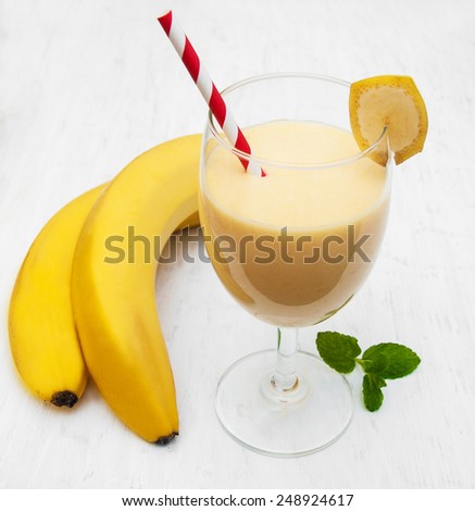 Banana smoothie on a old white wooden background