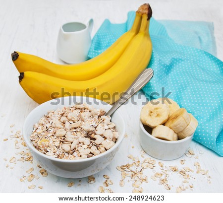 Banana and muesli on a old white wooden background
