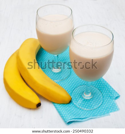 Banana smoothie  on a old white wooden background