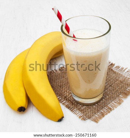 Banana smoothie on a old white wooden background