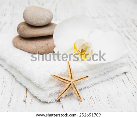 spa concept with stacked of stones starfish white flowers orchid and white towels