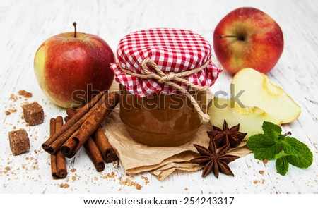 Apple jam and fresh apple on a wooden background