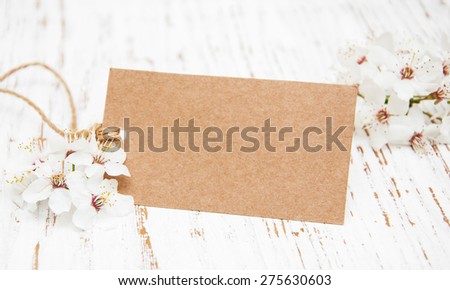 spring cherry blossom with card on a wooden background
